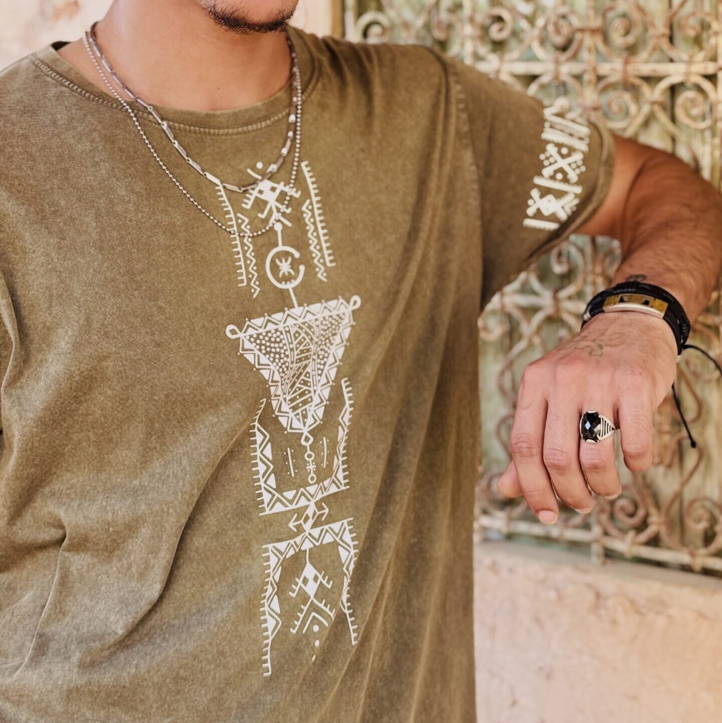 Olive Amazigh T-shirt with Tifinagh script embroidery and minimalist tribal motif.