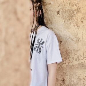 Femme portant le t-shirt en coton Afusart « Symbole de liberté », orné de motifs amazighs originaux.