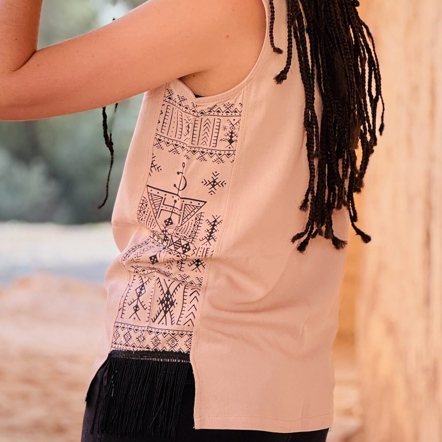 Beige sleeveless Amazigh top with bold white geometric side design