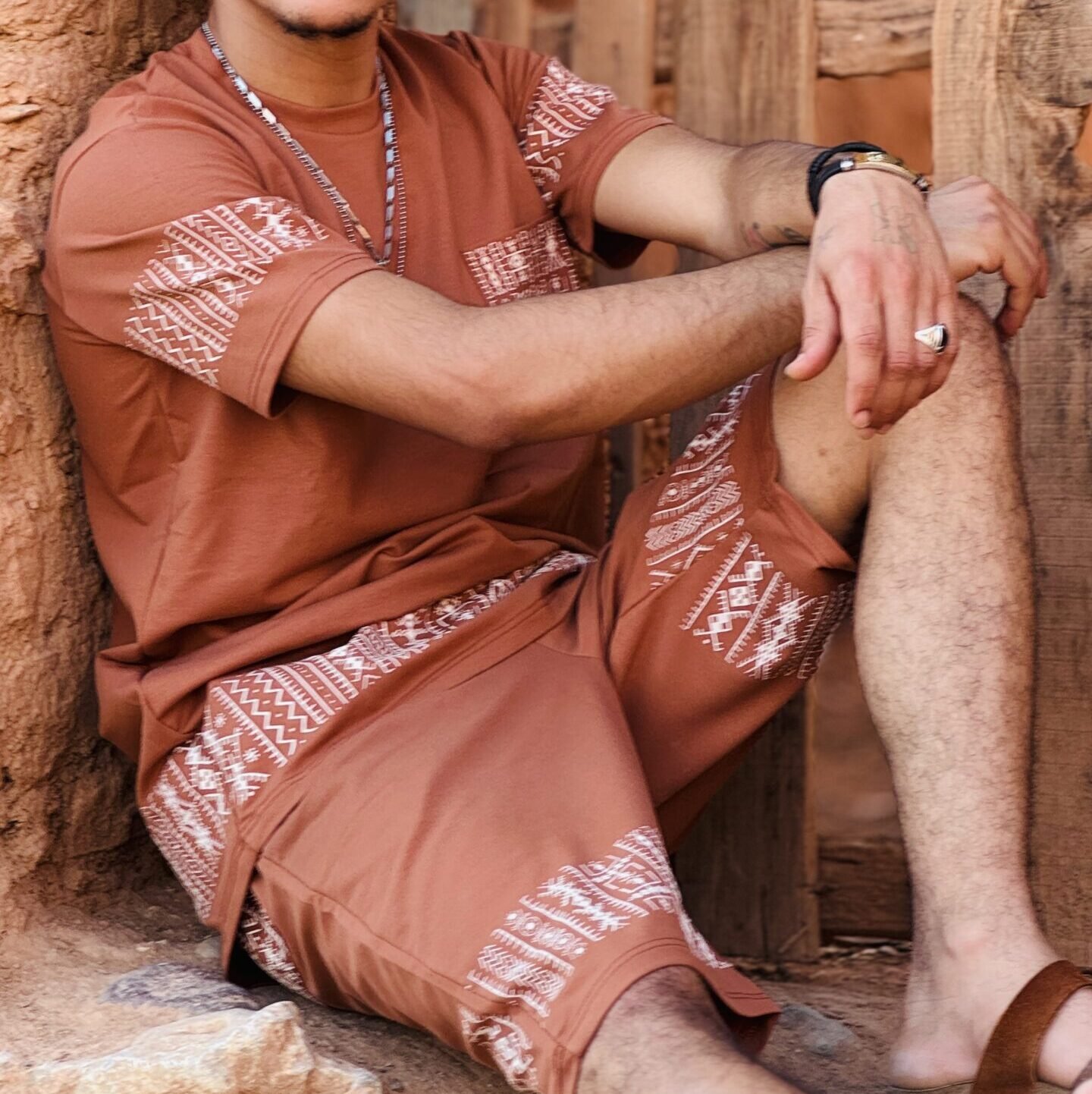 Terracotta Moroccan Amazigh two-piece outfit with white geometric embroidery on the T-shirt and matching shorts