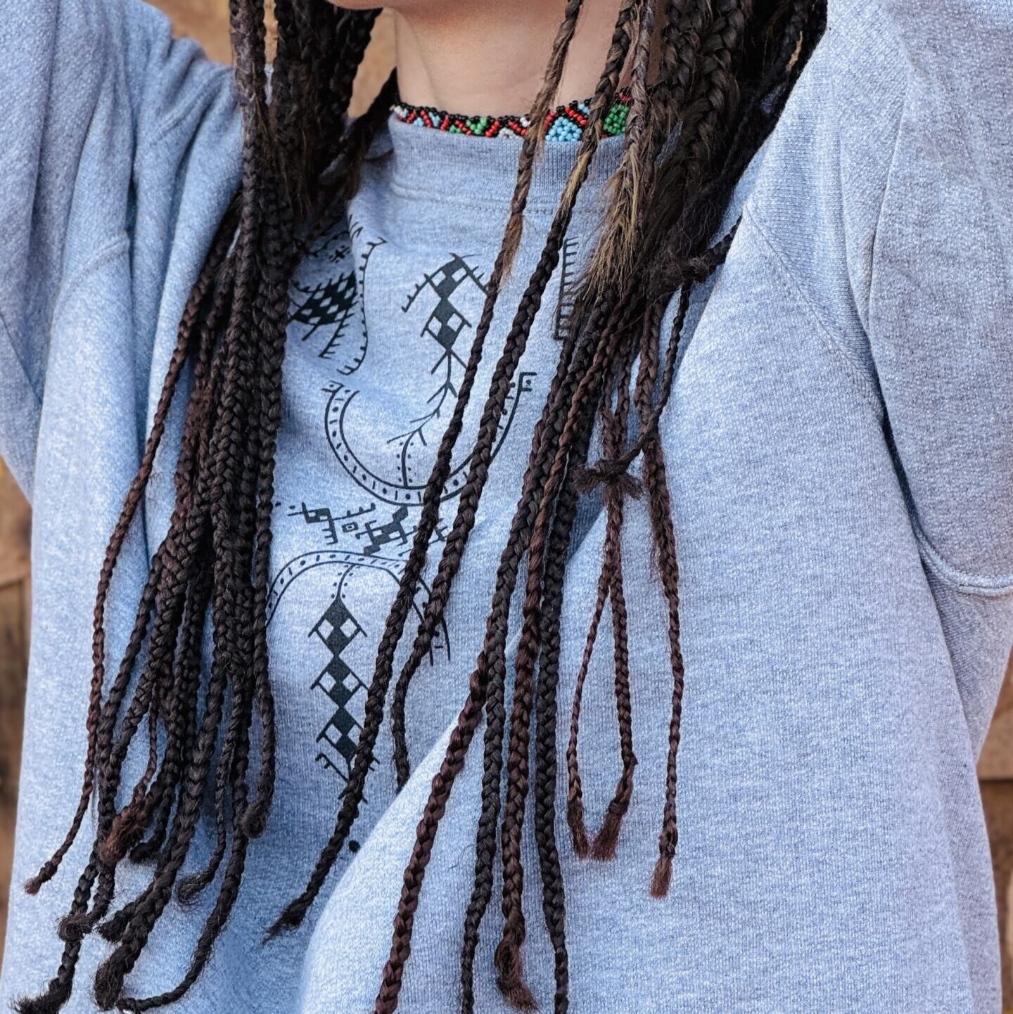 Gray sweatshirt featuring a bold white AZA Amazigh symbol on the front