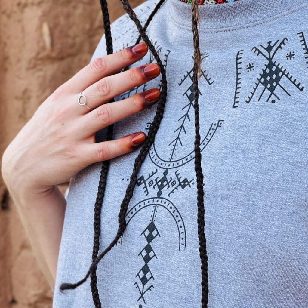 Gray sweatshirt featuring a distinctive white Amazigh-inspired geometric design