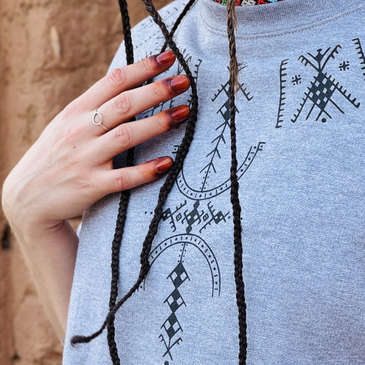 Gray sweatshirt featuring a distinctive white Amazigh-inspired geometric design