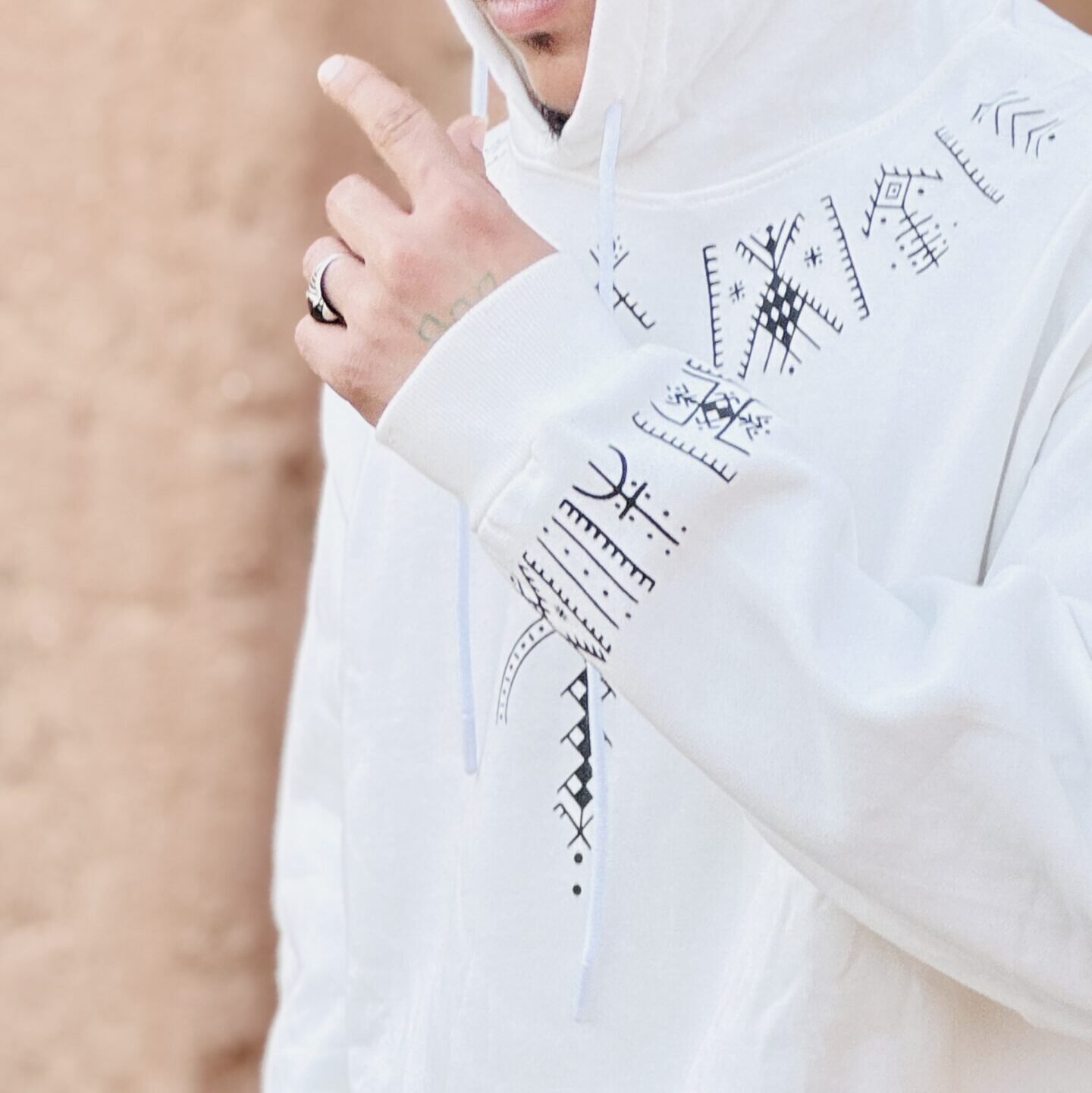 White Amazigh hoodie with black geometric design and traditional-inspired printed motifs