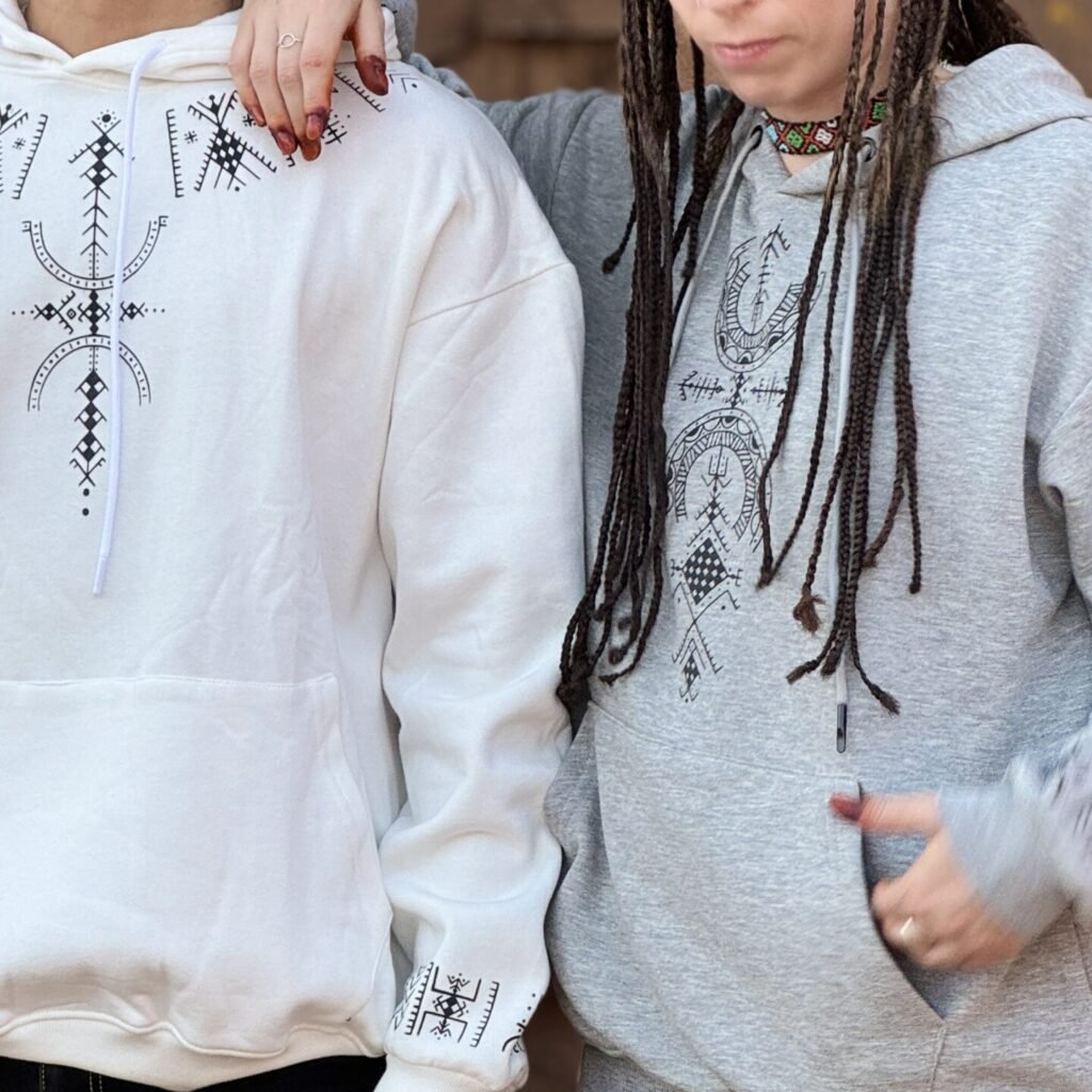 Gray and white Amazigh pullover hoodie with black geometric graphic motifs on the front and sleeve