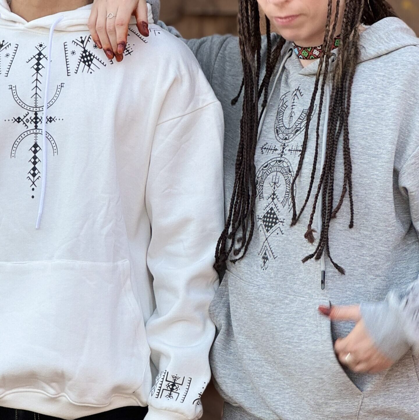 Gray and white Amazigh pullover hoodie with black geometric graphic motifs on the front and sleeve