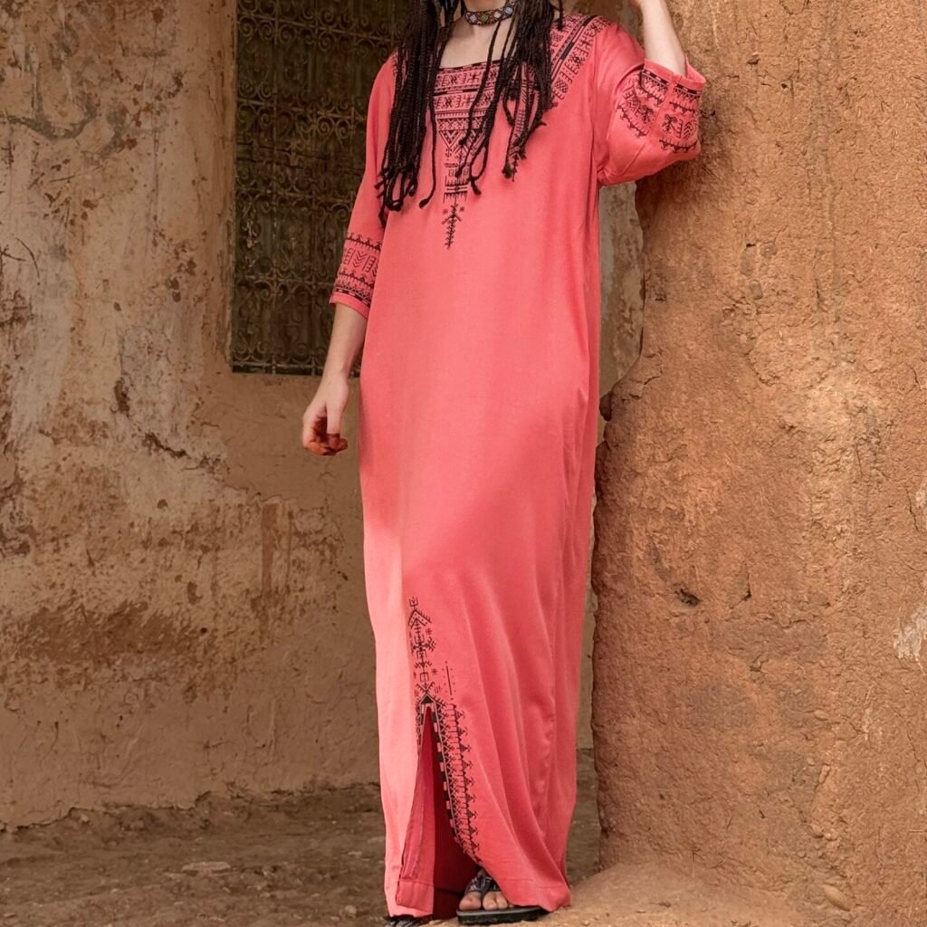 Pink robe featuring bold black Amazigh geometric embroidery