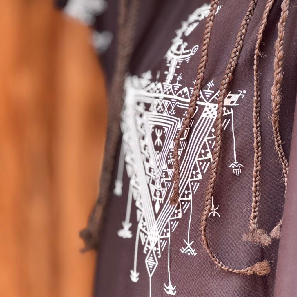 Black Moroccan Amazigh dress with colorful Tasghonst symbol and traditional geometric embroidery