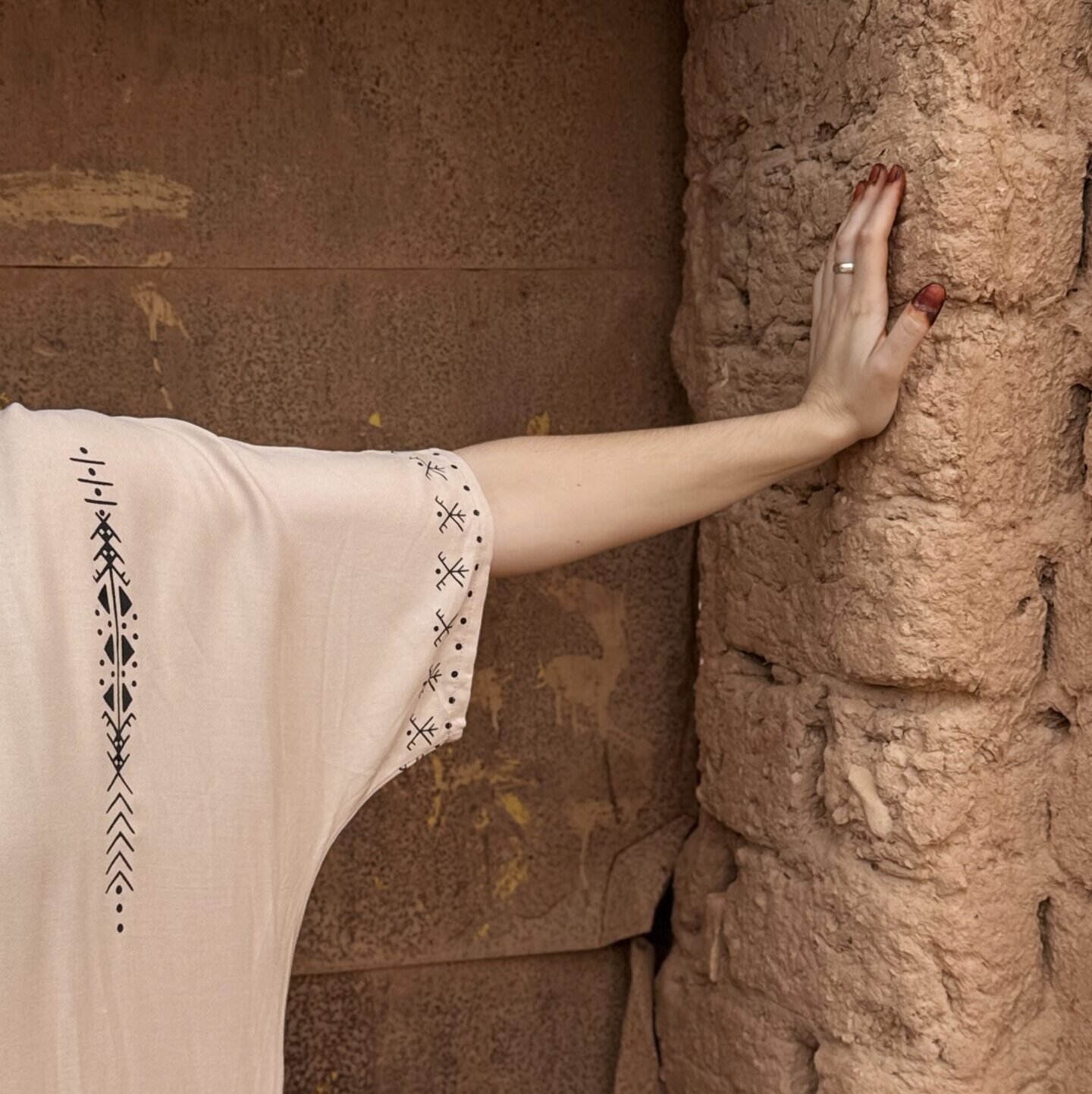 Cream Moroccan Amazigh dress with black geometric embroidery and traditional motifs