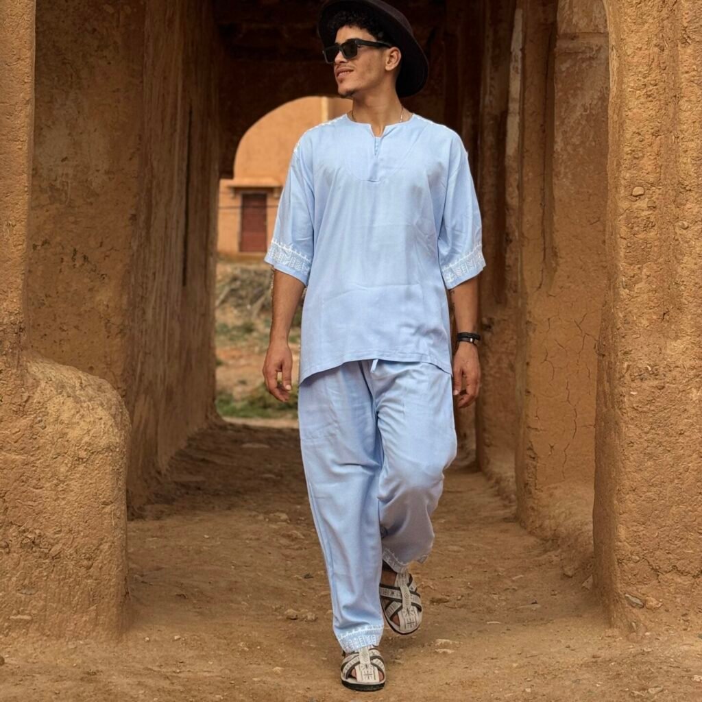 Light blue Moroccan Amazigh men’s outfit with white embroidered geometric patterns