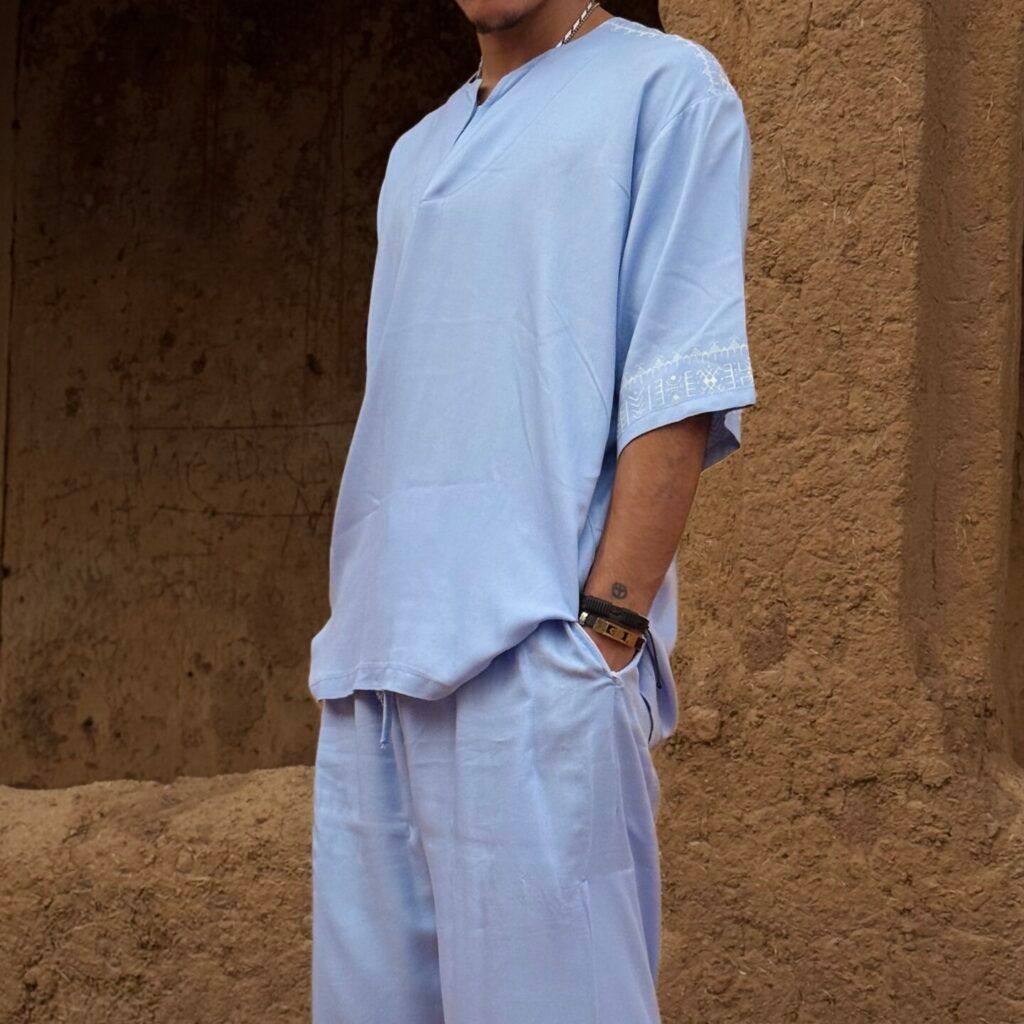 Light blue Moroccan men’s outfit with white geometric embroidery on sleeve and trouser hems