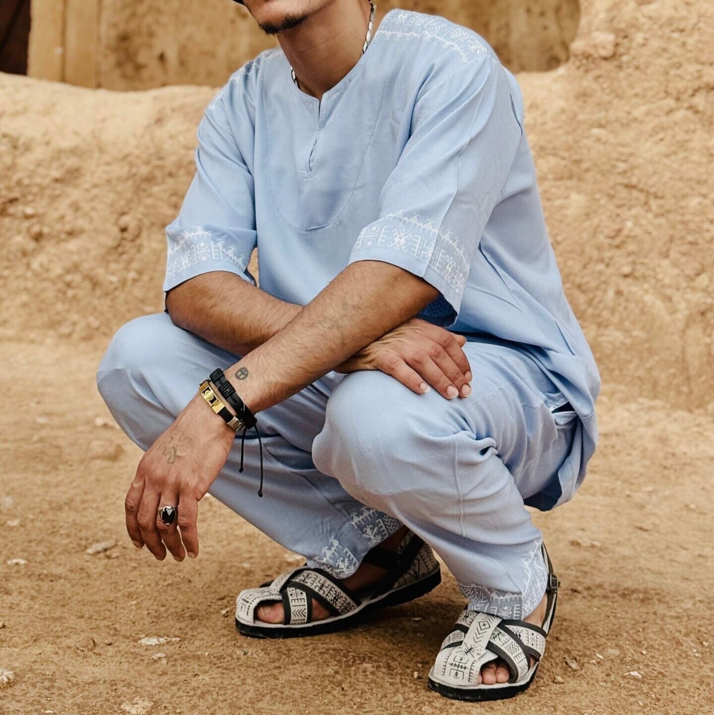 Light blue traditional Moroccan men’s set with white decorative stitching on sleeves and trouser hems