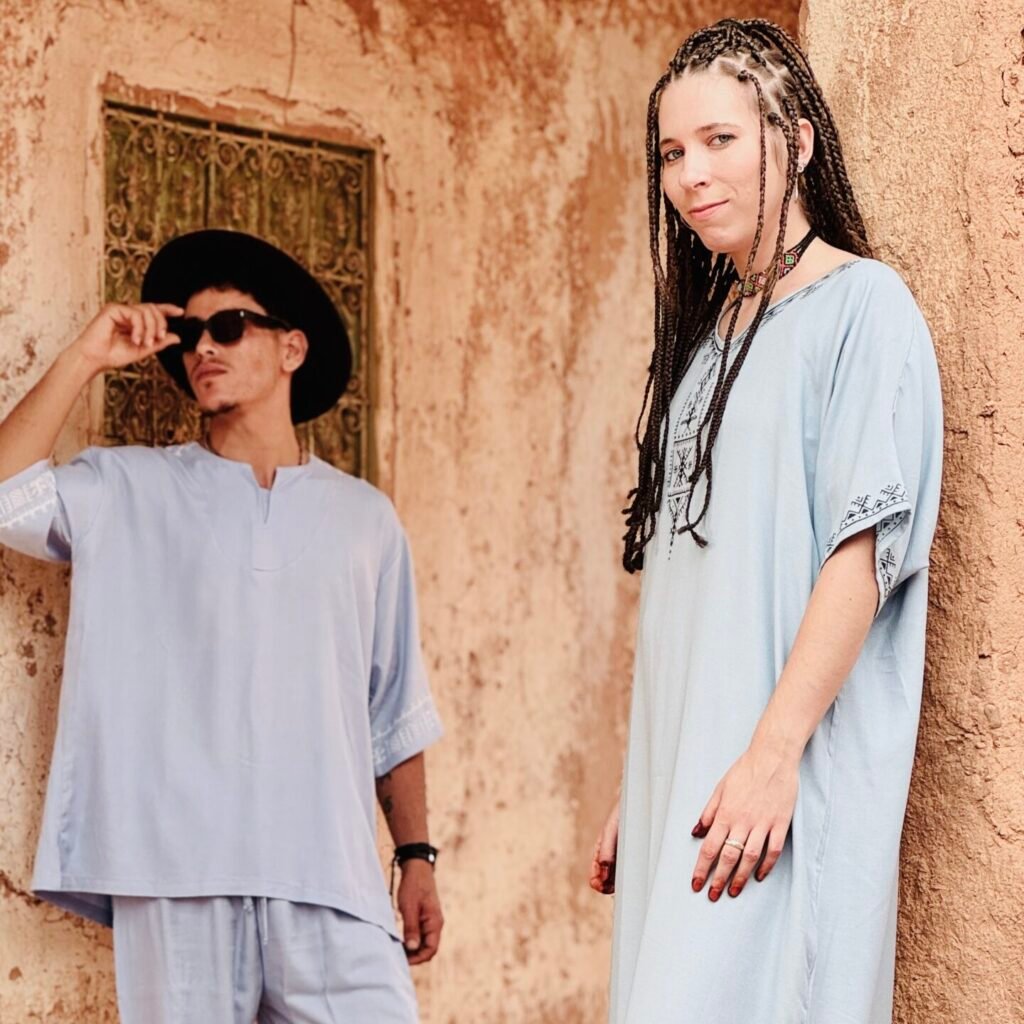Man in a grey outfit and girl in a light blue Amazigh robe