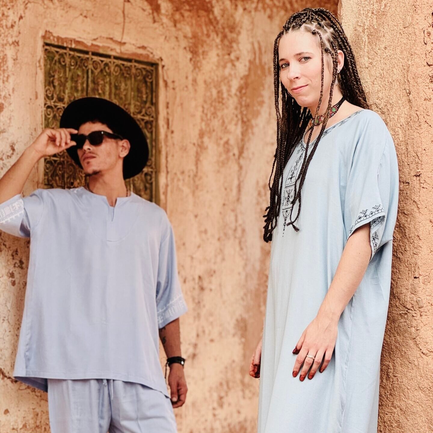 Man in a grey outfit and girl in a light blue Amazigh robe