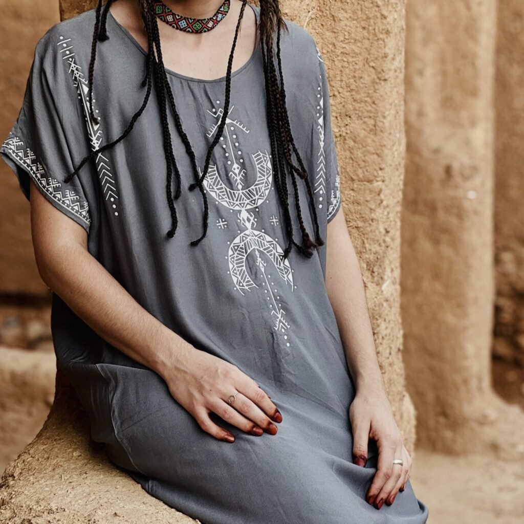 Gray Moroccan Amazigh dress with white geometric embroidery and colorful traditional Amazigh necklace