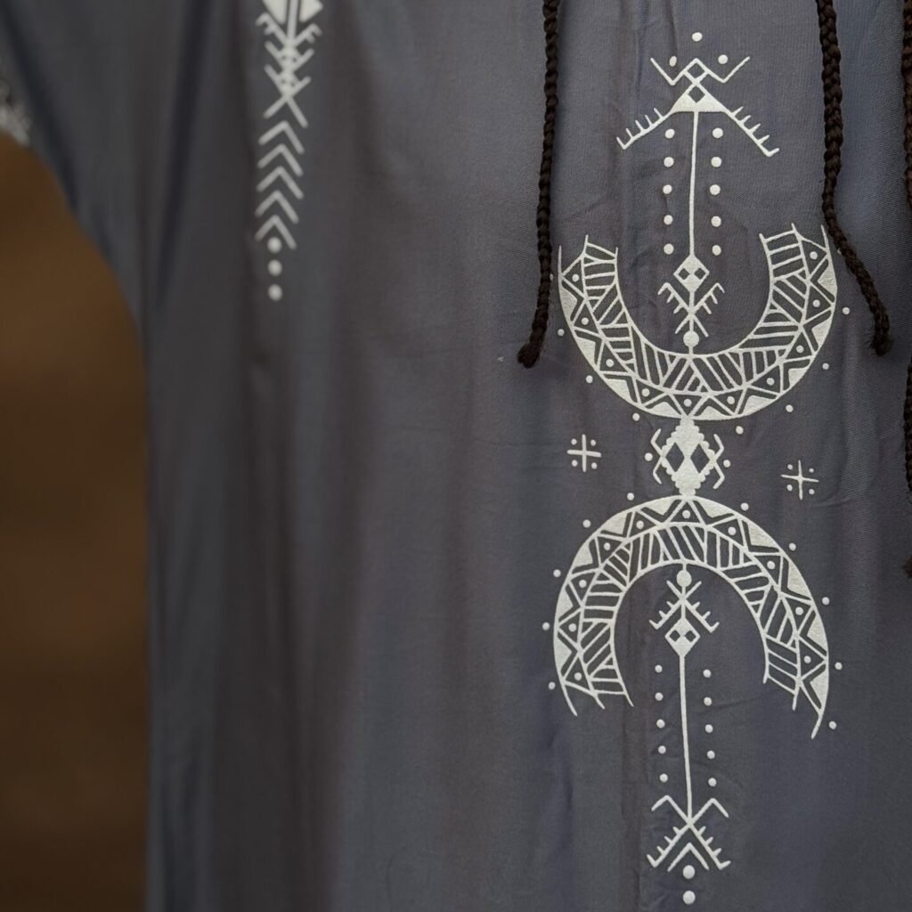 Gray Moroccan Amazigh dress with white geometric embroidery and traditional motifs, paired with a colorful Amazigh necklace