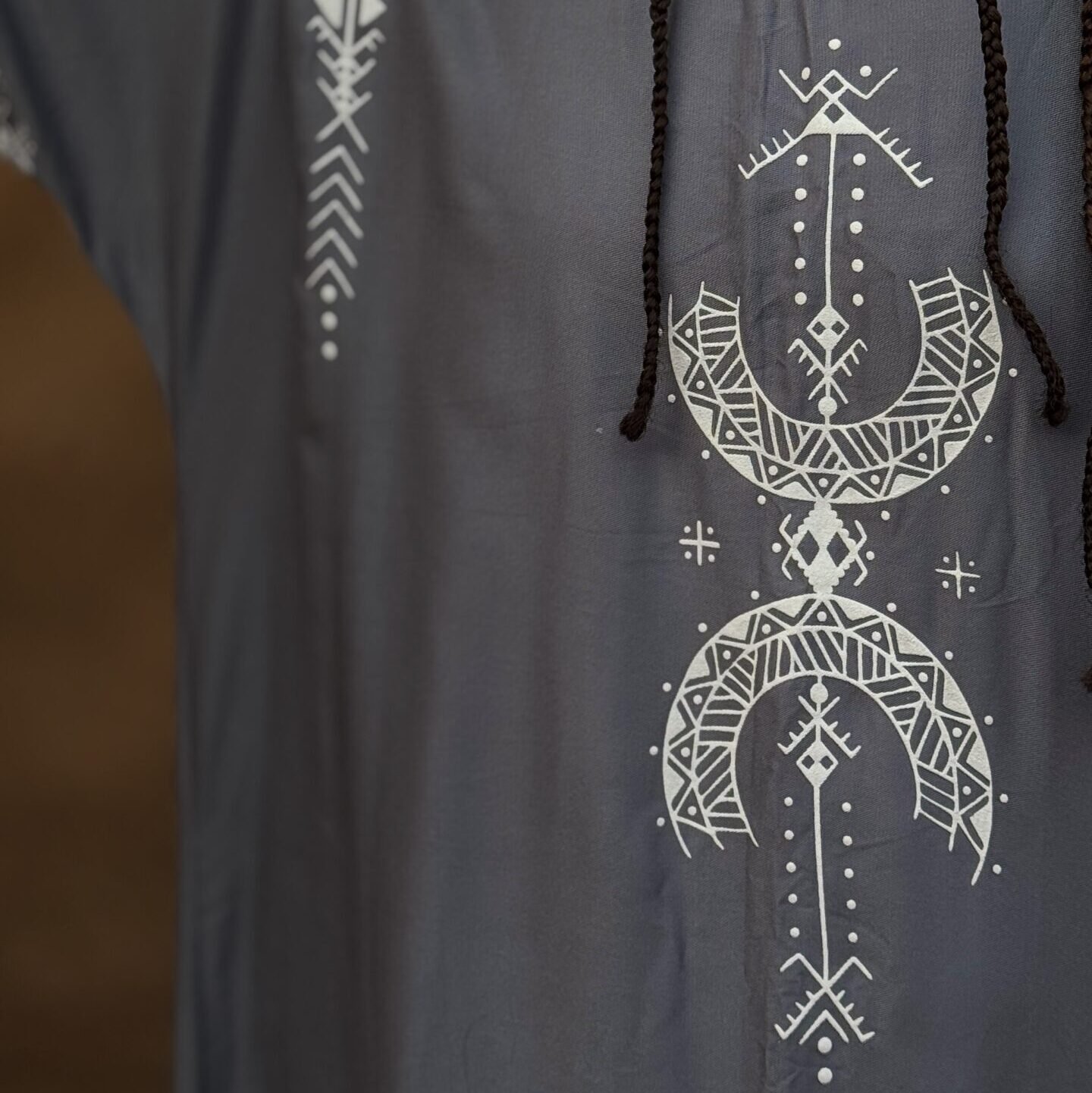 Gray Moroccan Amazigh dress with white geometric embroidery and traditional motifs, paired with a colorful Amazigh necklace