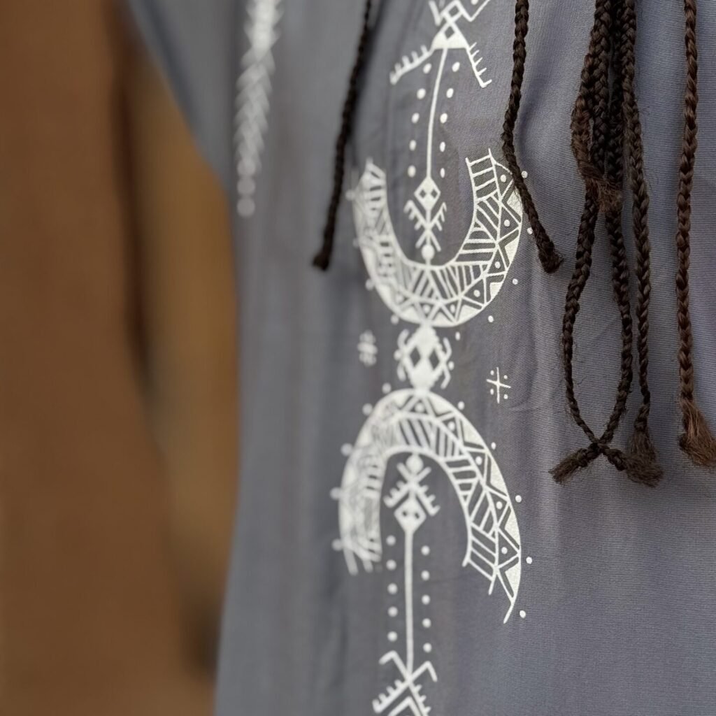 Gray Moroccan Amazigh tunic with white traditional geometric symbols and decorative motifs