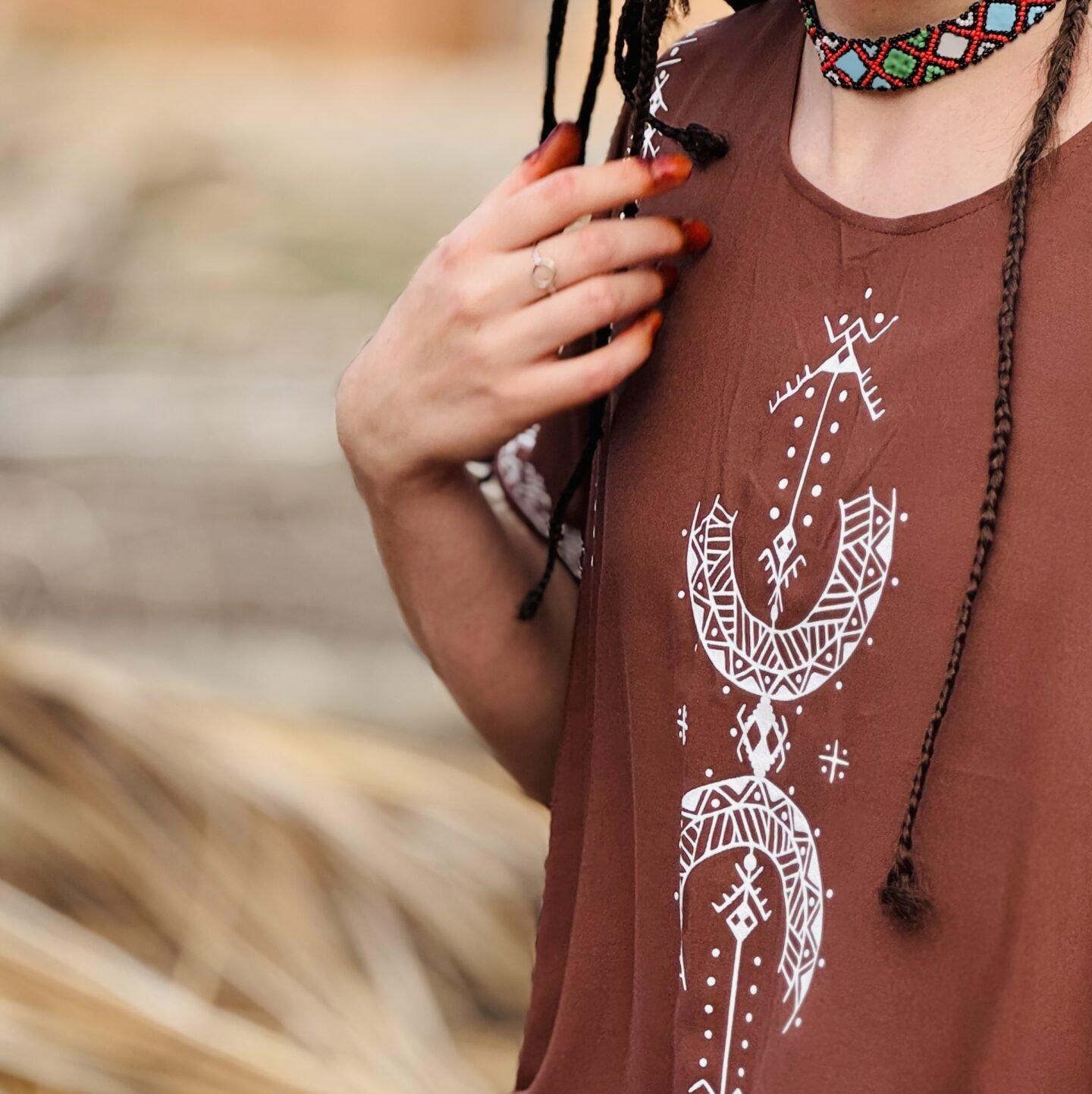 Brown Moroccan Amazigh dress with white traditional symbols and colorful geometric Amazigh necklace
