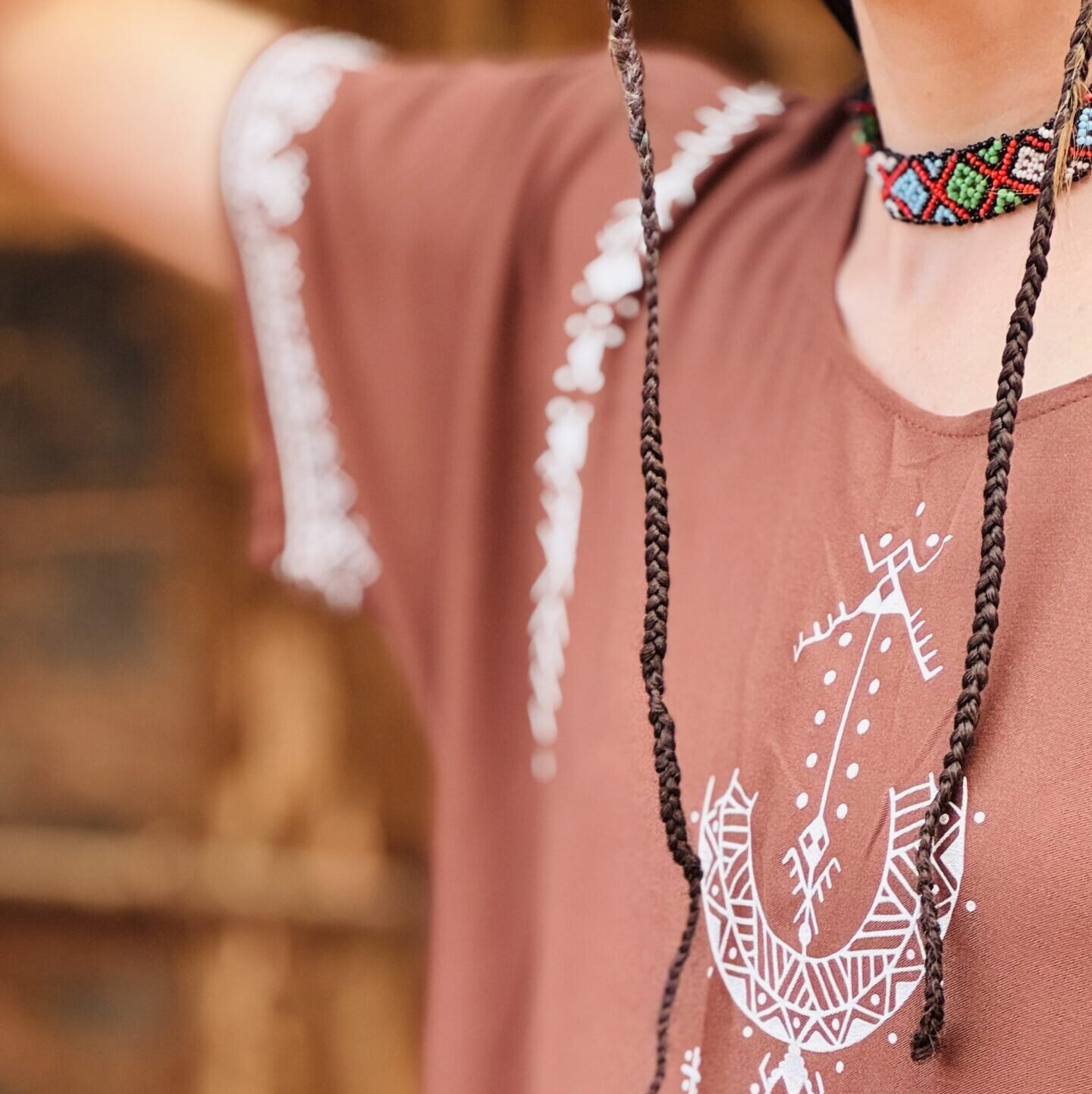 Brown Moroccan Amazigh dress with Aza symbol, white geometric embroidery, and colorful traditional motifs