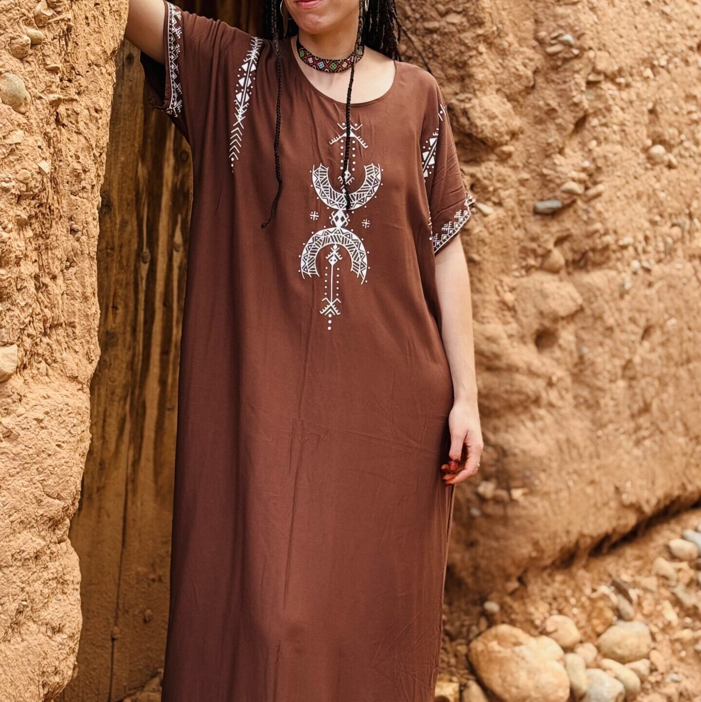 Brown Moroccan Amazigh dress with Aza symbol, white geometric embroidery, and traditional motifs
