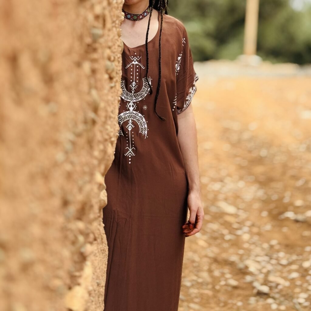Brown Moroccan Amazigh dress with Aza symbol, white geometric embroidery, and traditional Amazigh motifs