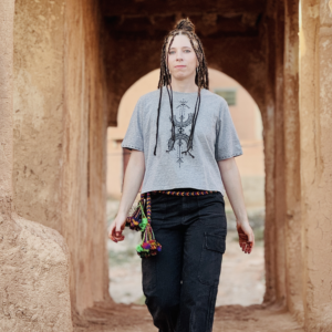 Femme portant un crop top en coton Afusart, orné de motifs amazighs blancs originaux.