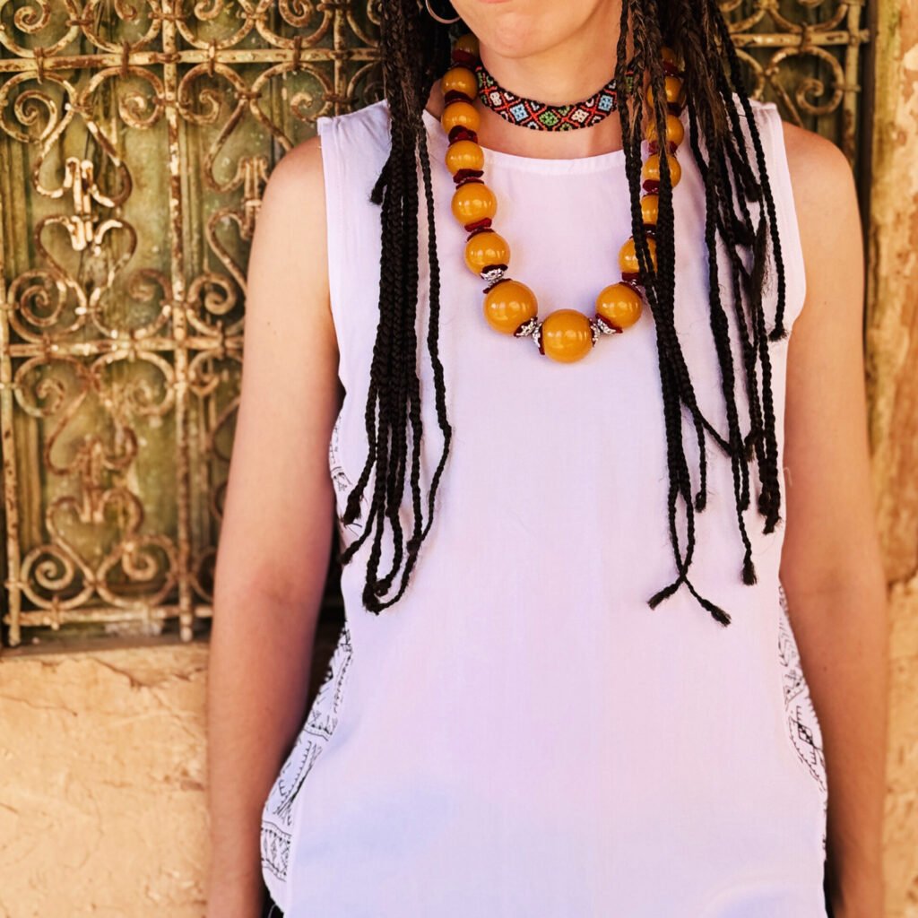 White sleeveless top with black and white Amazigh geometric side panels