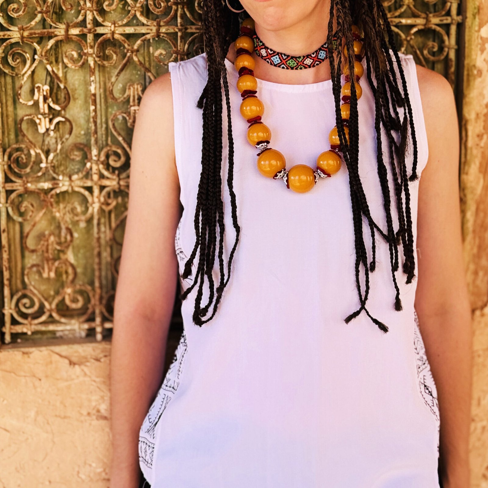 White sleeveless top with black and white Amazigh geometric side panels