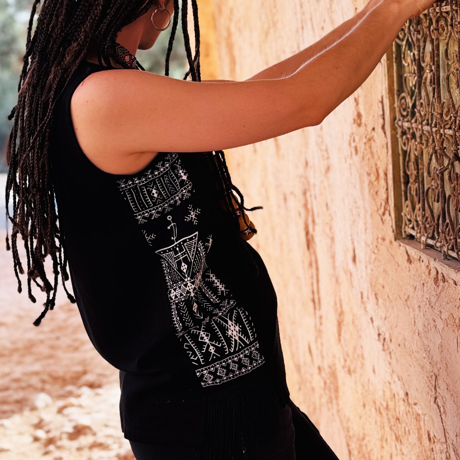 Black sleeveless top with colorful Amazigh geometric design on the front