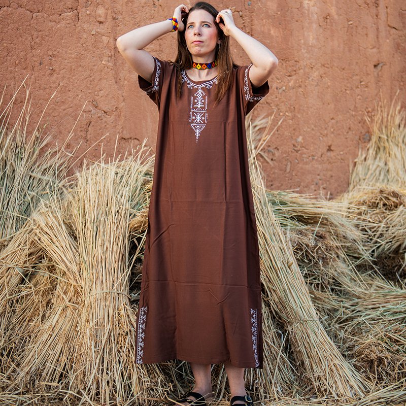 Brown Amazigh gandora with white geometric embroidery on the neckline, sleeves, and lower sides