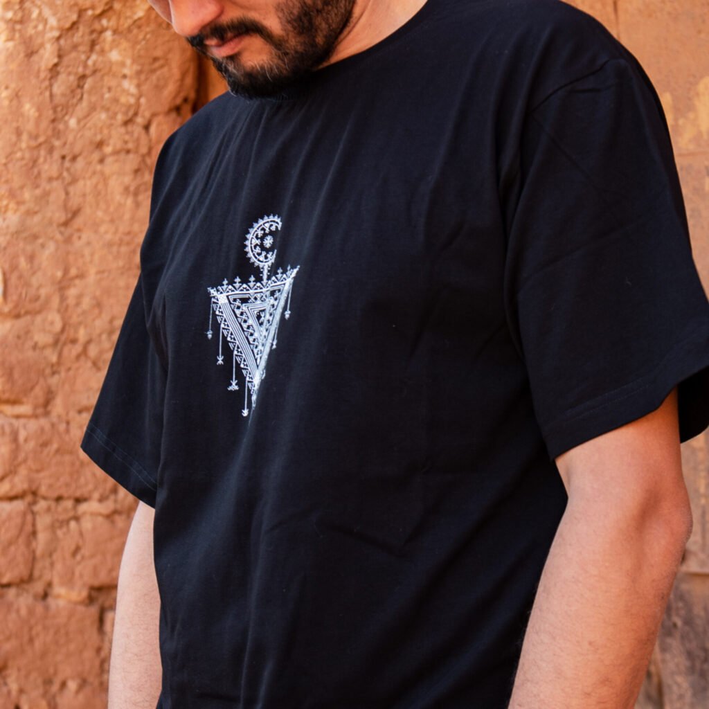 Black TASGHNST T-shirt with white Amazigh geometric symbol on the chest
