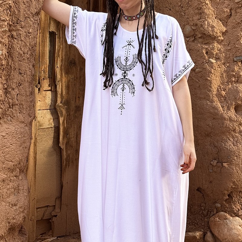 White Amazigh dress featuring the AZA symbol in black on the front and sleeves