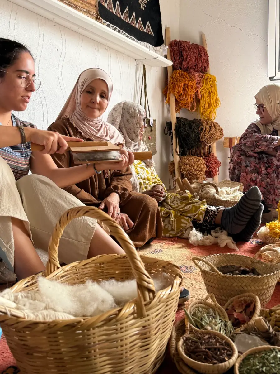 Tourists learning how traditional Moroccan rugs are made in a local weaving workshop