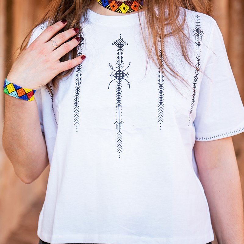 White Amazigh crop top with blue Berber geometric motifs and Moroccan-inspired design