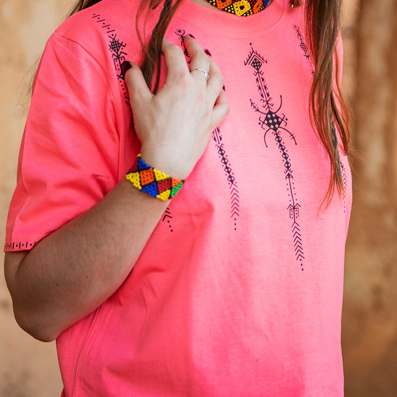 Bright pink Amazigh crop top featuring black AZA symbols and geometric decorative motifs